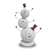 Tin tabletop decoration depicts three snowmen